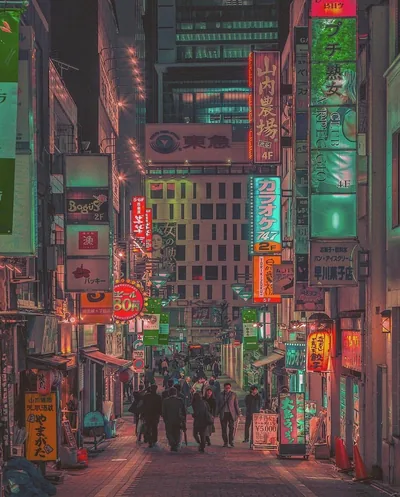 Sign-covered buildings close in over a pedestrian street washed in retro green film tones, walkers reduced to silhouettes across the lower quarter.