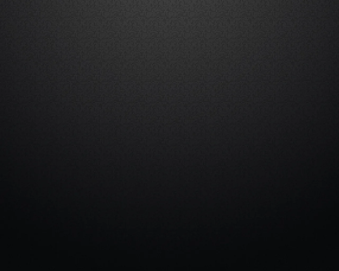 A fine-grained charcoal surface lit faintly from the upper left, the light thinning out as it reaches the lower corners.