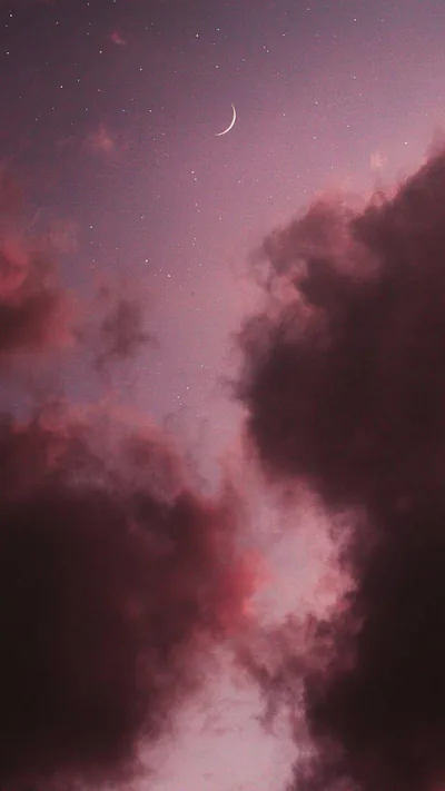 Dusty-pink cloud towers rise either side of a starlit gap, a thin crescent at the top; the open channel between them leaves room for a lock-screen clock.