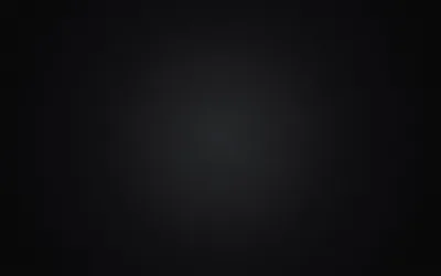 A diffuse grey glow sits slightly above centre and falls away evenly in every direction, leaving the corners in near-total black.