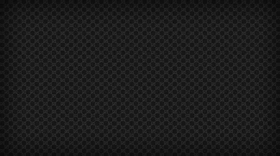 A fine square weave of carbon fibre repeats edge to edge, a heavy vignette pulling the four corners down to solid black.