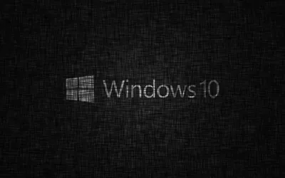 The window mark and the Windows 10 name sit small at the centre of a woven charcoal backdrop.