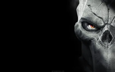 The same pale skull mask turns three-quarters toward the camera on the right, deep fissures across the brow catching a cold grey light.