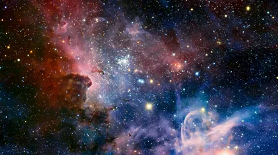 Wide view of the Carina Nebula with red dust towers on the left and a blue gas plume lower right, star-filled from corner to corner.