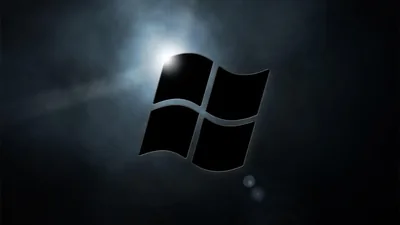 The window mark sits in silhouette against a burst of white light coming from directly behind it.