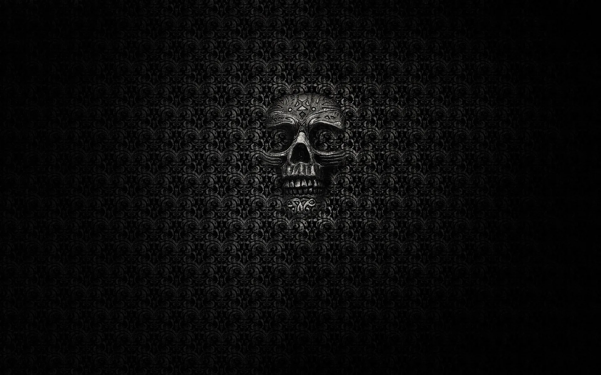 The skull is built out of the same tiny scrollwork that tiles the whole background, so it only surfaces where the pattern turns lighter.
