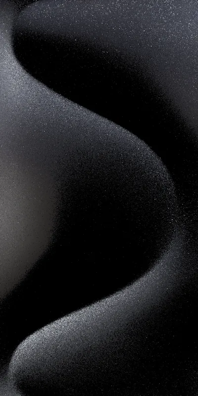 Smooth dark folds curve down the frame like wind-shaped sand, finished with a fine grain.