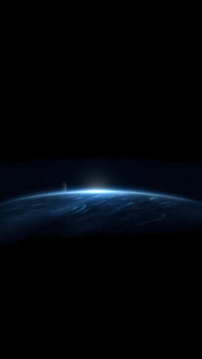 The planet's edge glows blue with a pinpoint of white sun breaking over the horizon, the upper half of the frame empty black.