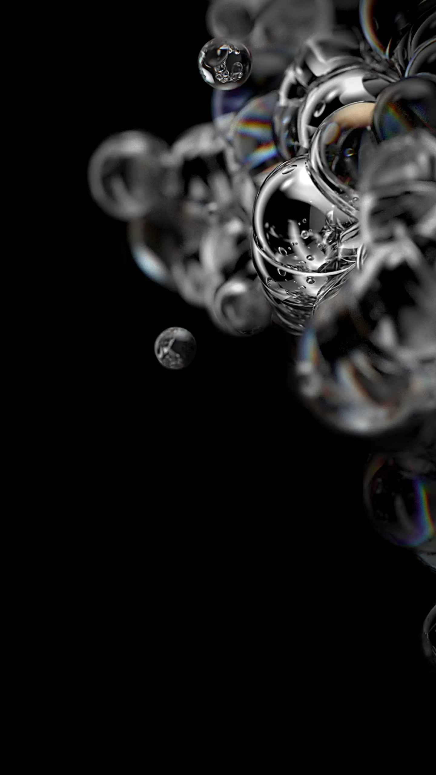A cluster of glass-like bubbles gathers in the upper half of a vertical black frame, each one catching a thin rainbow along its rim.