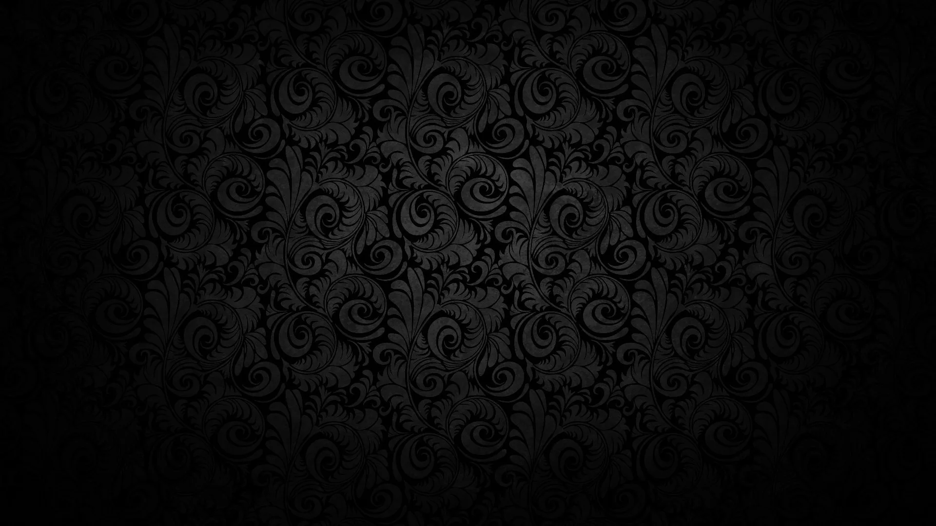 Worn damask curls spread across the centre in dim grey and dissolve into heavy black at every edge, the texture rough like aged fabric.