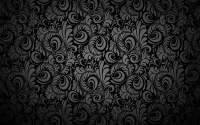 Dense curls of leaf and shell scroll cover the frame in charcoal relief, the light strongest across the middle so the right edge sinks into black.