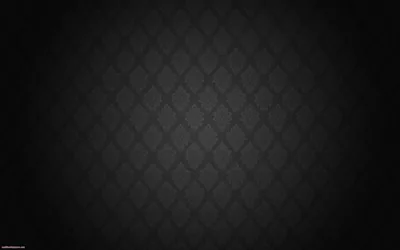 A diamond quilt repeat in charcoal on black, brighter at the centre and fading to the edges.
