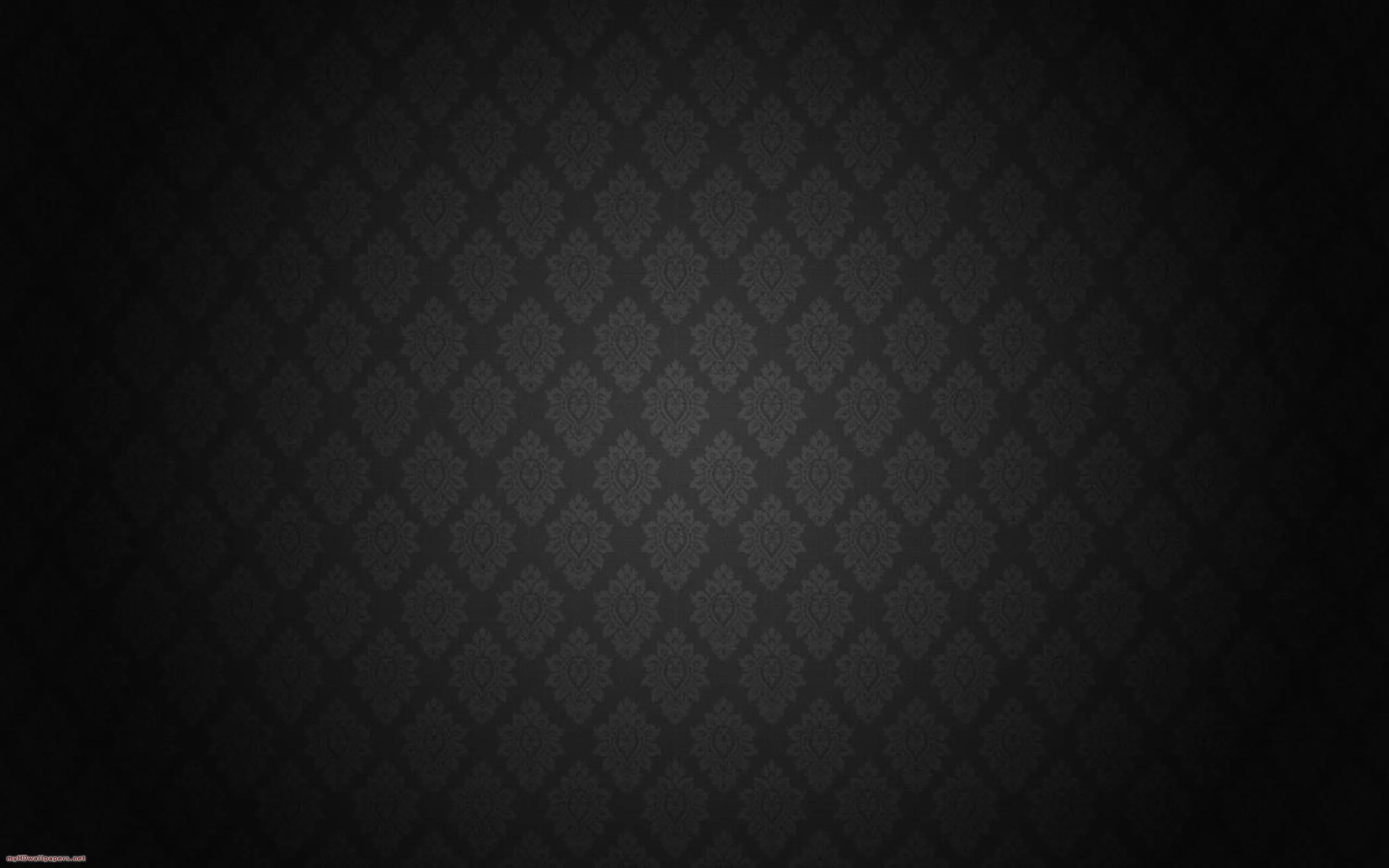 A diamond quilt repeat in charcoal on black, brighter at the centre and fading to the edges.
