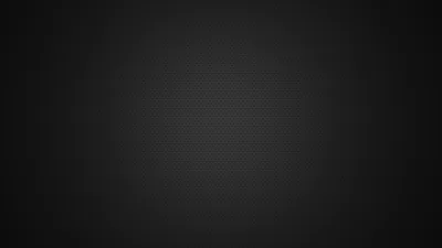 Barely-there horizontal ridges cover a charcoal surface that brightens slightly in the middle and sinks to black in every corner.