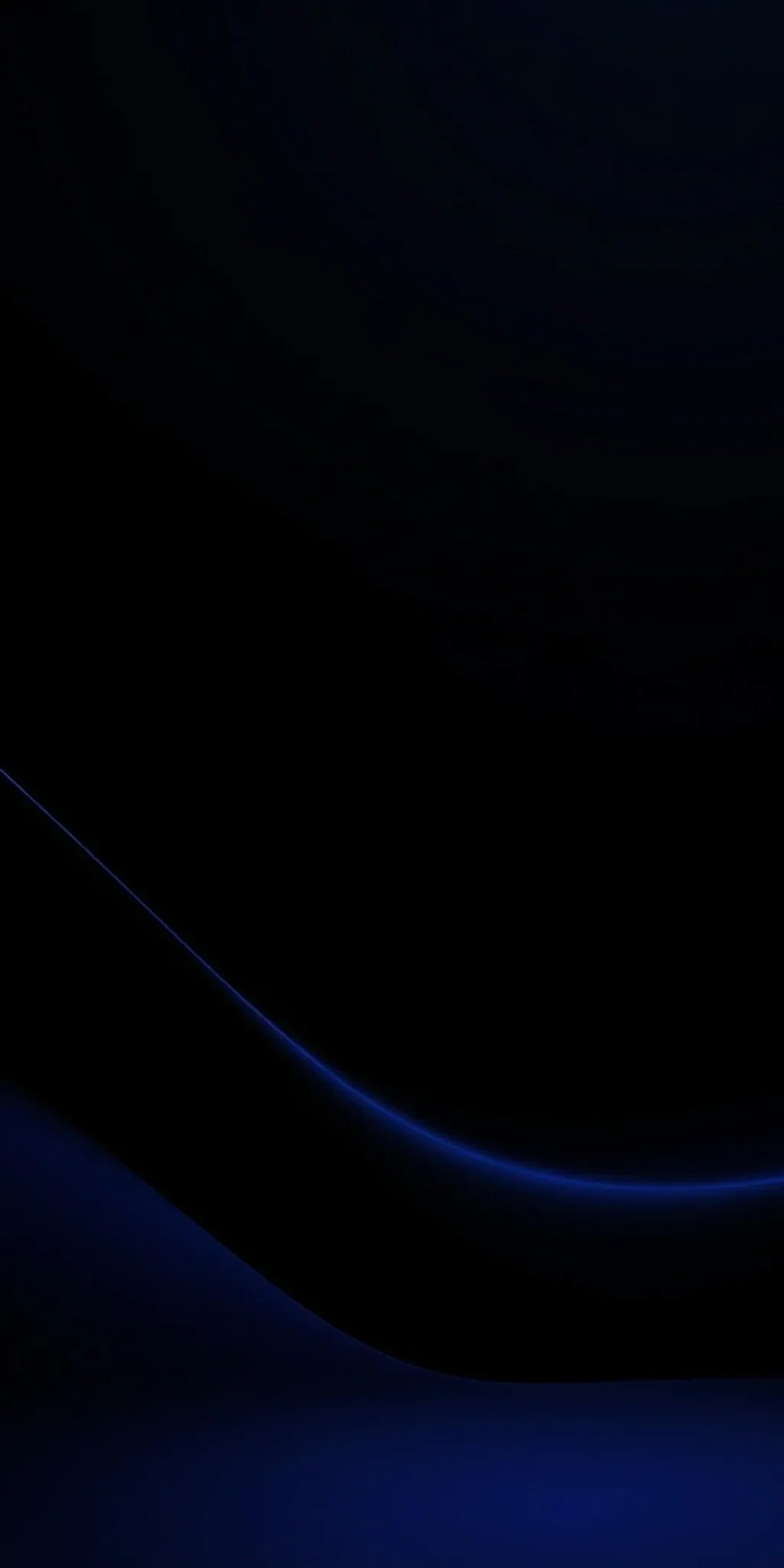Almost the entire frame is black, broken only by a soft blue arc sweeping along the bottom and a dim glow at the very base.