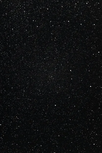 A tight scatter of white pinpricks across true black, no moon or horizon — the kind of even texture that keeps an OLED panel mostly off.