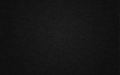 Tight woven denim in near-black, the diagonal thread showing only as fine grain, evenly lit corner to corner.