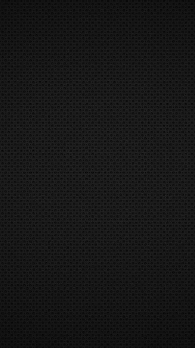 A dense grid of tiny raised dots covers the whole frame in black, lit from the top so the texture reads clearly at the edges and vanishes in the middle.