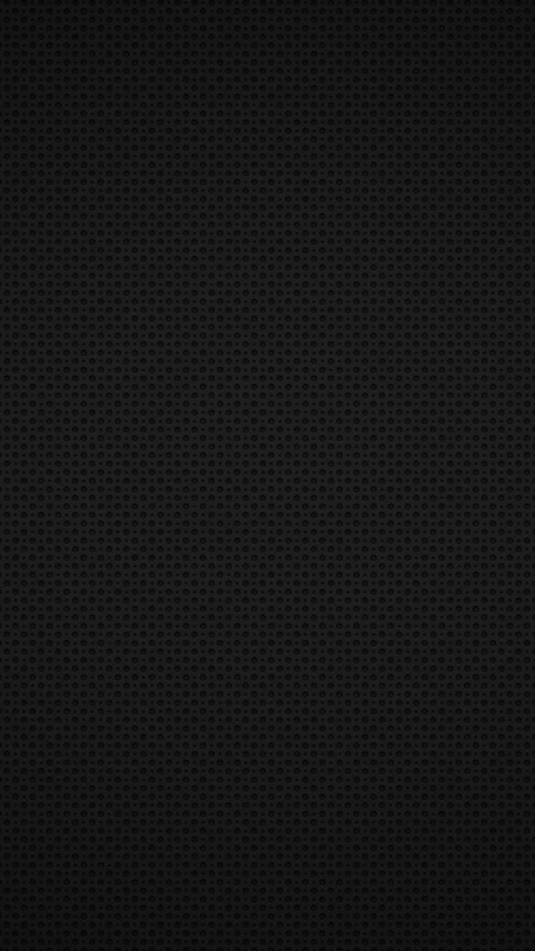 A dense grid of tiny raised dots covers the whole frame in black, lit from the top so the texture reads clearly at the edges and vanishes in the middle.