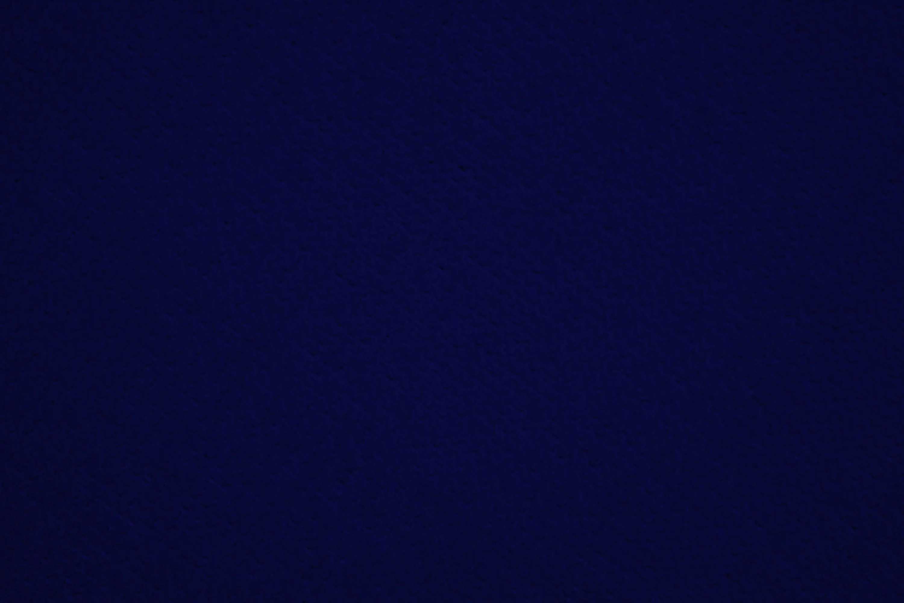 A flat, unbroken field of deep navy with the faintest lift toward the centre — plain enough to sit behind icons or text anywhere on screen.