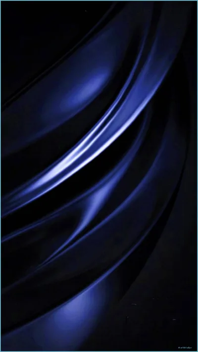 Broad folds of blue-black fabric sweep across the frame, one bright crease running diagonally while the corners fall away into shadow.