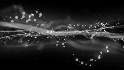 A ribbon of light runs horizontally through the frame with bright particles floating loose above and below it.