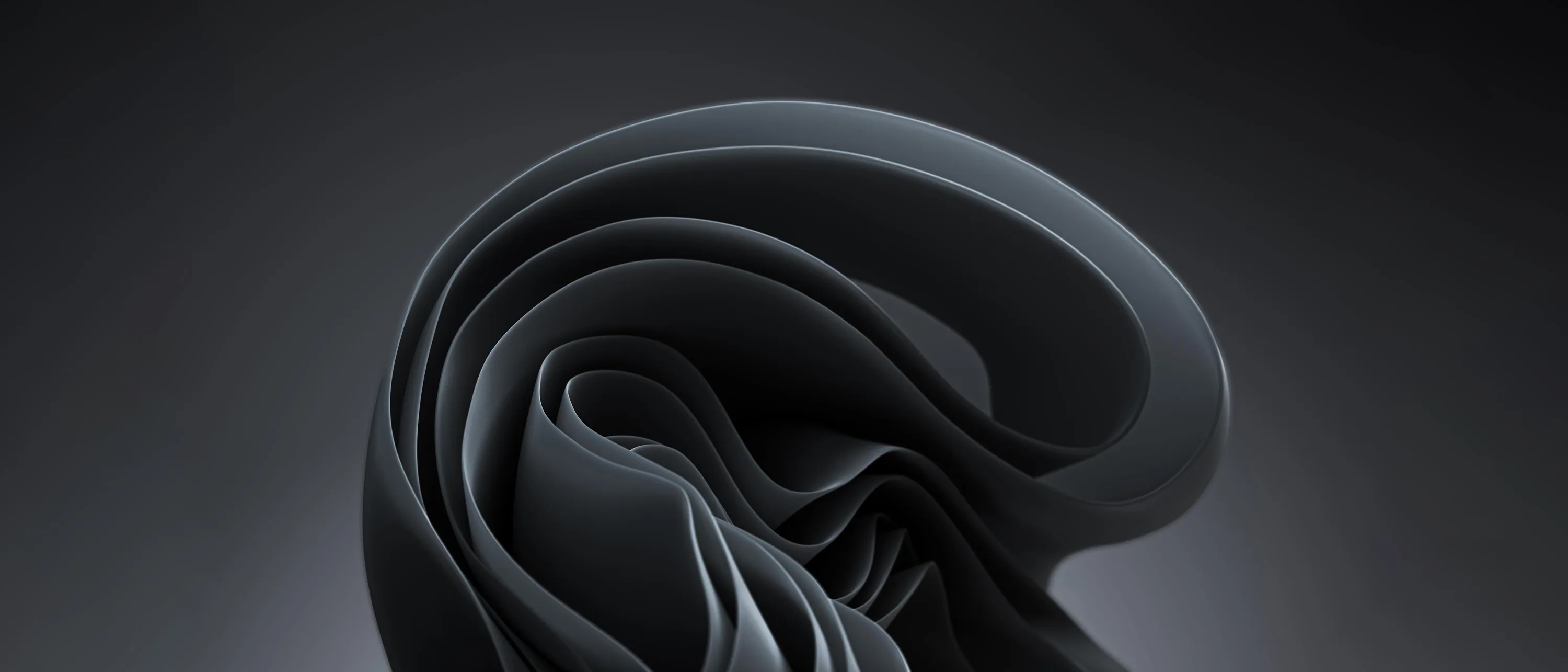 A glossy black ribbon loops back on itself in the centre of the frame, its curves catching a cool grey rim light.