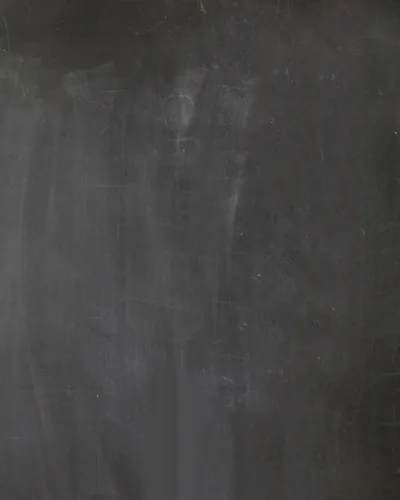 A tall crop of dark grey cloth with chalky smudges and faint vertical wear marks, lit softly from the upper left so the weave stays visible.