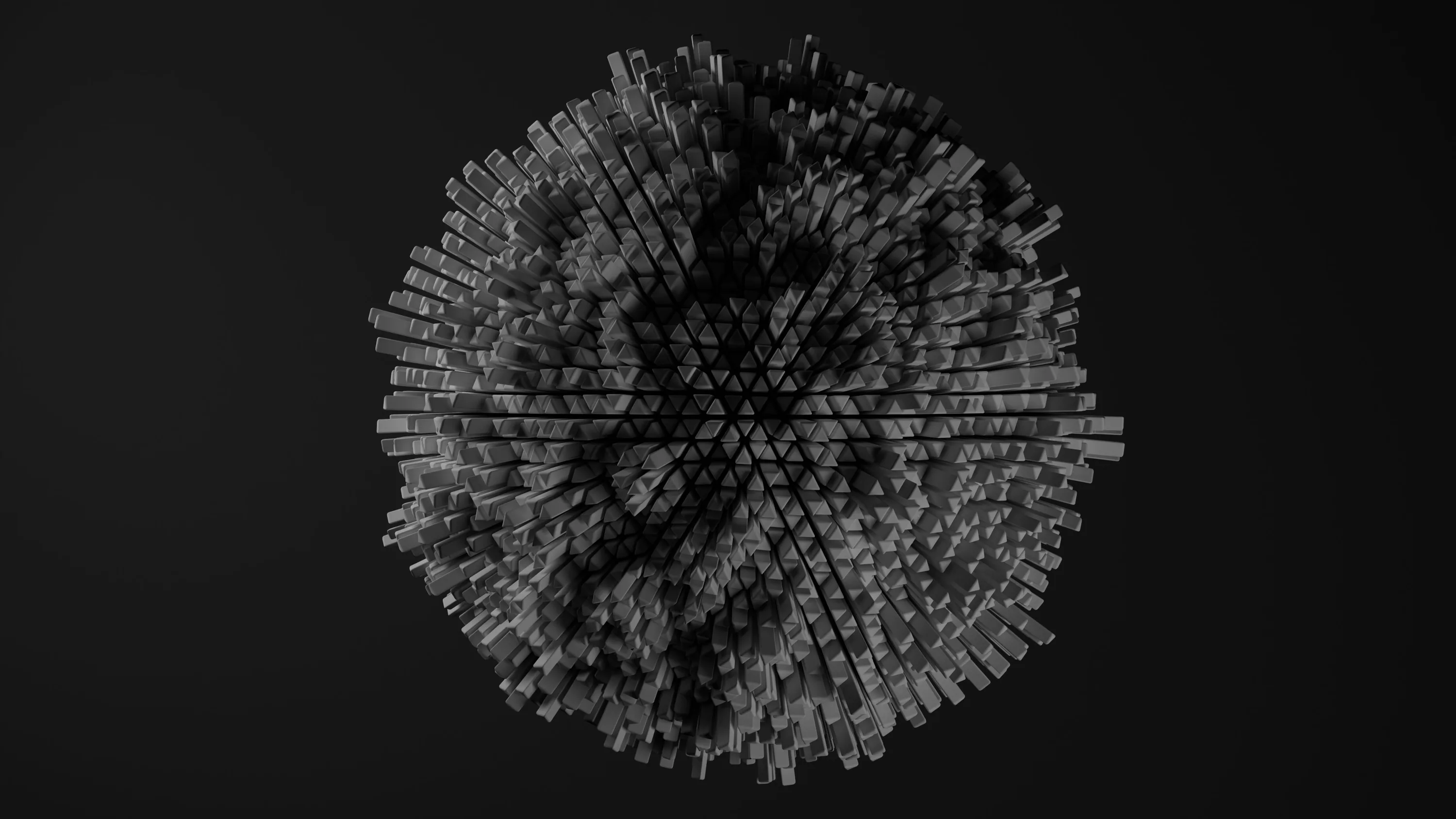 Thousands of tiny grey cubes pack into a rough sphere at the centre of a soft black field, lit from the upper left so one side stays in shadow.