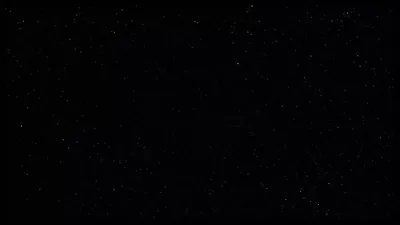 Small white stars scatter unevenly across a near-black sky, denser along the top than the bottom.