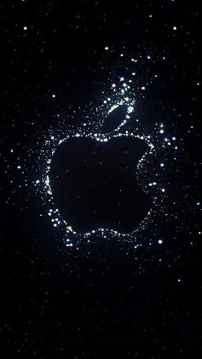The Apple mark drawn out of scattered blue and white particles that orbit its outline, the rest of the frame deep space black.