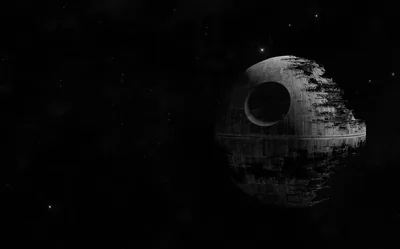 The Death Star hangs to the right in near-monochrome, its concave dish in shadow and faint stars scattered across the black.