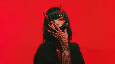 Curved horns and a tattooed forearm against a flat red backdrop, her face half hidden behind a black mask and blunt fringe.