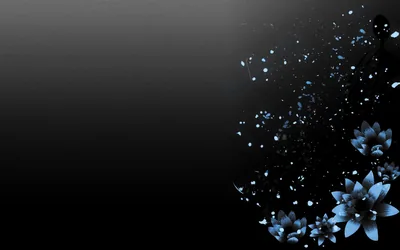 Blue petals break apart into flying fragments along the right edge, the left two-thirds left as a clean dark gradient.