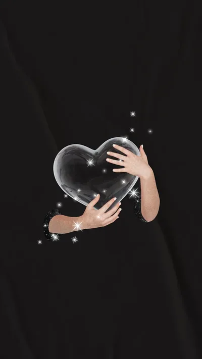 Two arms wrap around a transparent heart at the centre of a black frame, small sparkles scattered around the grip.