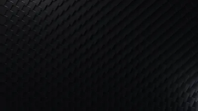 Rows of soft diamond shapes cover a dark surface, the light coming from the right and dying out at the left edge.