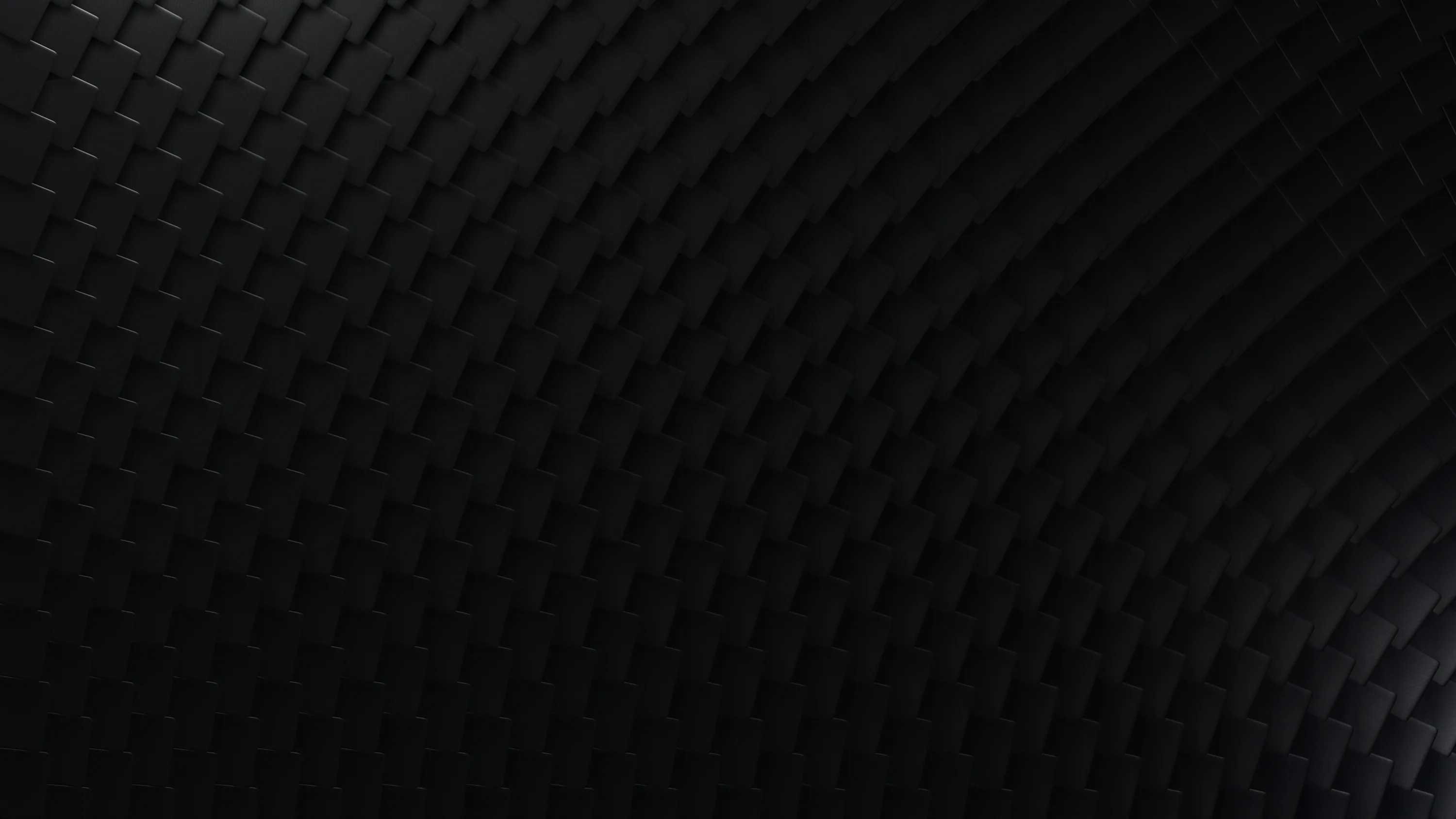 Rows of soft diamond shapes cover a dark surface, the light coming from the right and dying out at the left edge.