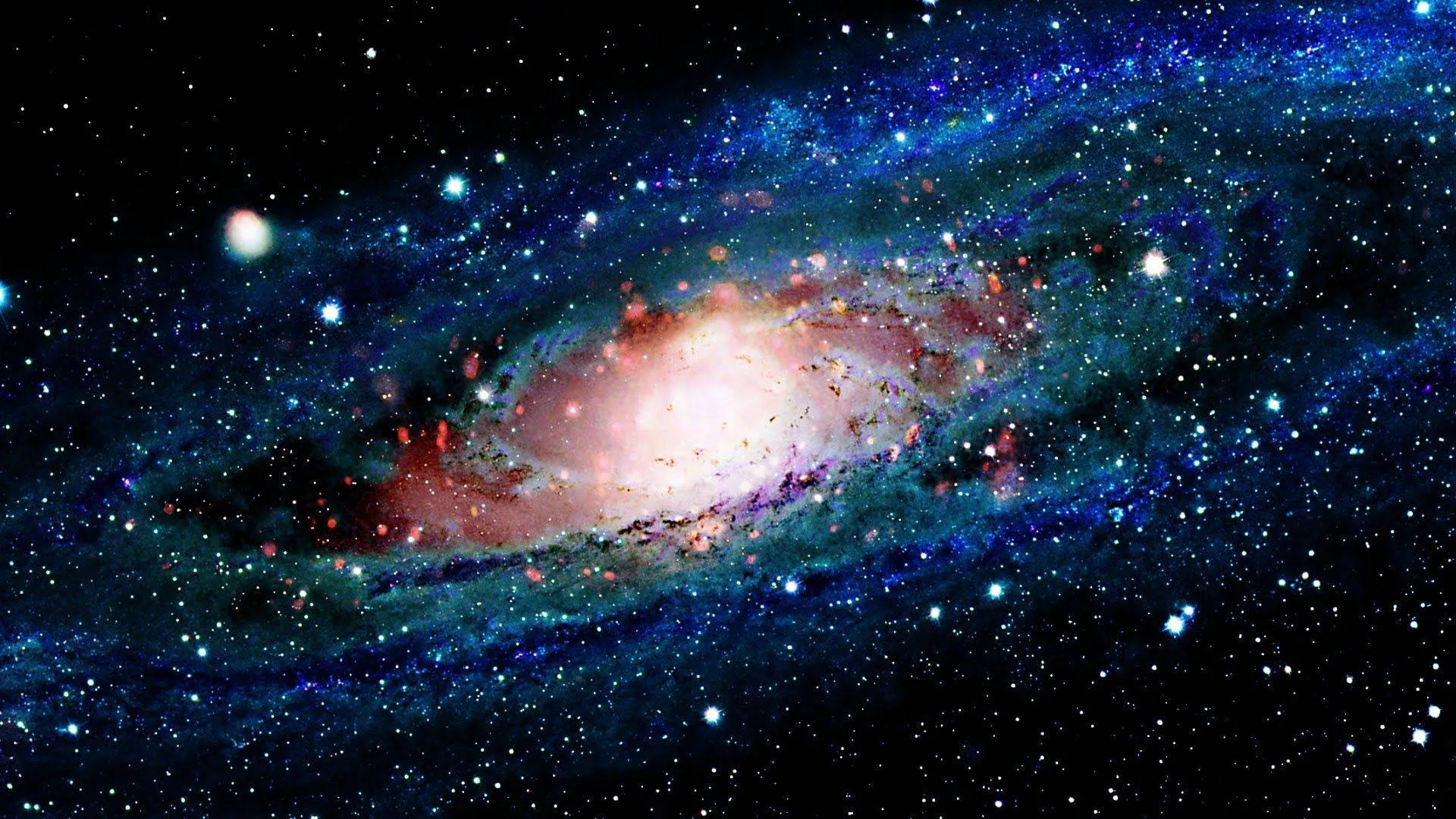 Spiral arms in teal and green wheel around a blazing white-pink core, bright stars spiking blue at the corners of the frame.