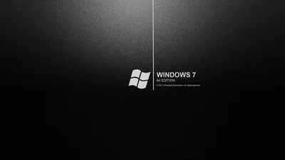 The Windows 7 mark and name sit to the right of a thin dividing line on a smooth dark grey field.