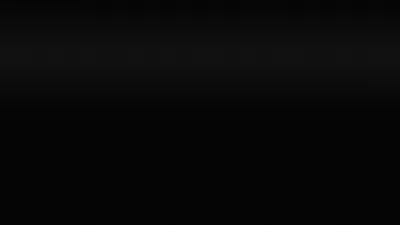 A narrow strip of dim light runs along the very top of a wide black frame, the remaining four fifths dropping to an unbroken black.