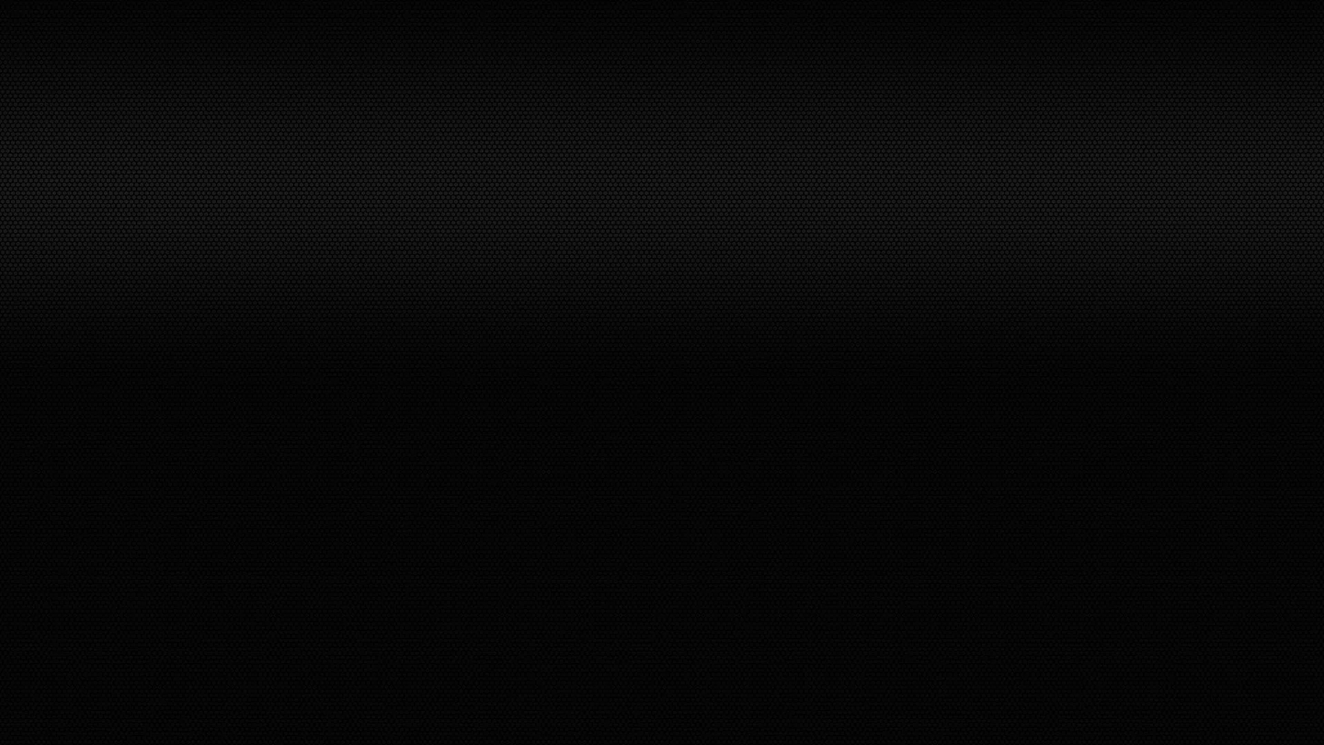 A narrow strip of dim light runs along the very top of a wide black frame, the remaining four fifths dropping to an unbroken black.
