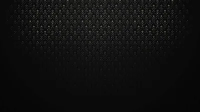A repeating grid of small studs runs across the top half in charcoal, then dissolves into flat black before it reaches the bottom edge.