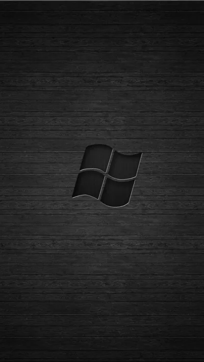 The four-pane Windows mark sits embossed at the centre of a dark grained wood panel.