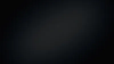 A soft charcoal smudge runs diagonally through the middle of an otherwise flat black screen, leaving all four corners clear for icons.