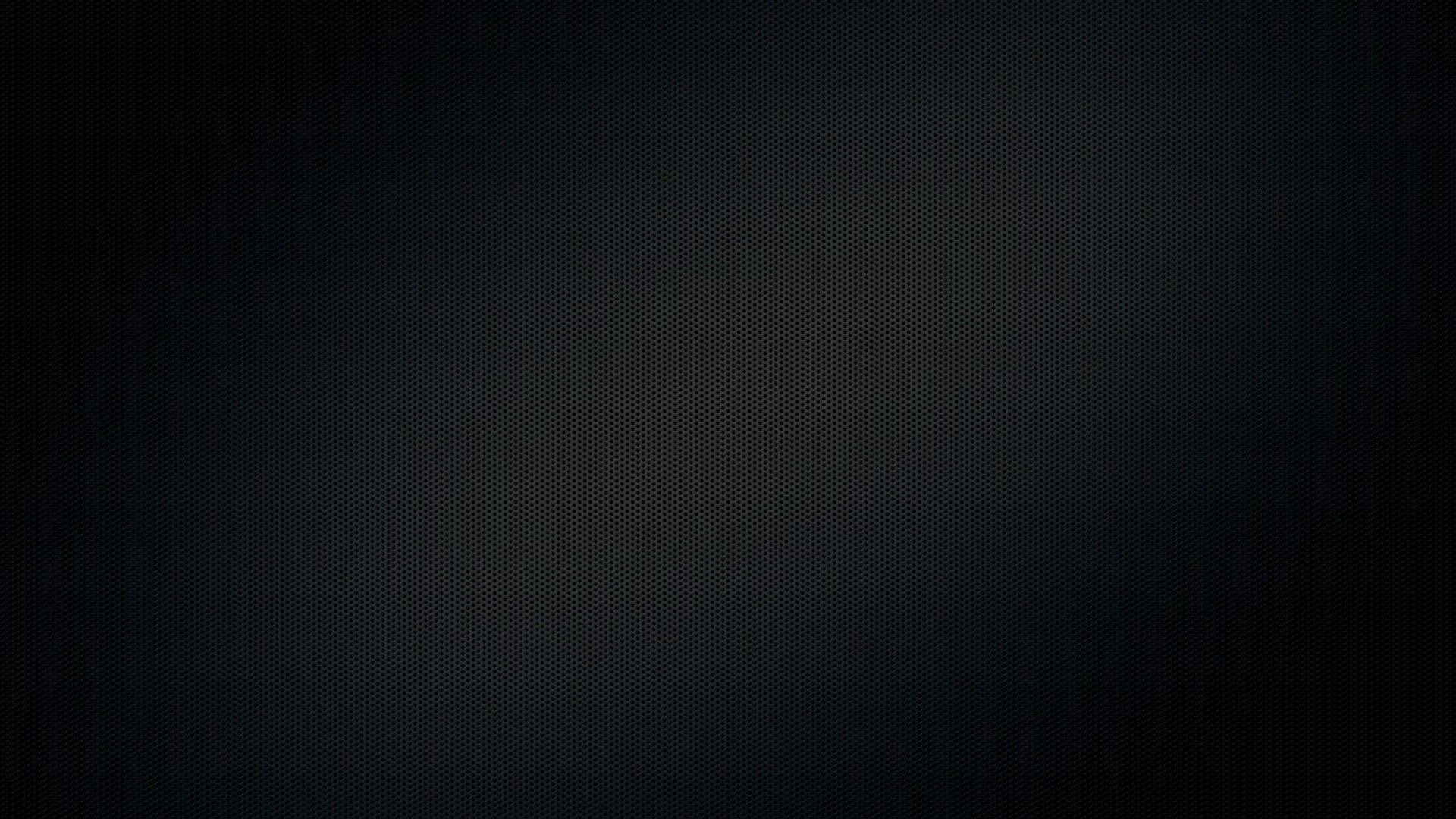 A soft charcoal smudge runs diagonally through the middle of an otherwise flat black screen, leaving all four corners clear for icons.