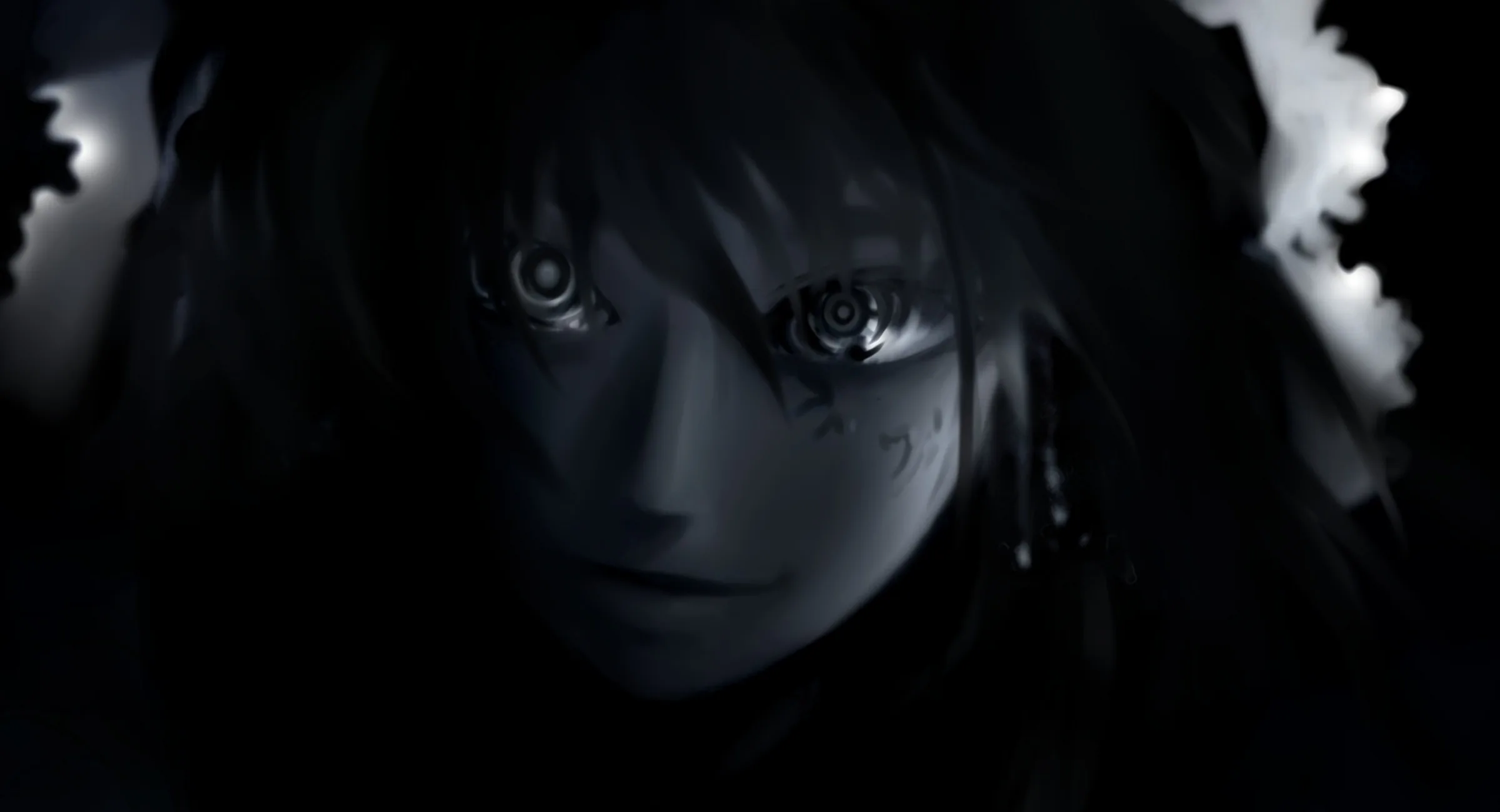 A face pushes out of near-total black, only the wide eyes and a thin blue edge along the hair catching any light.