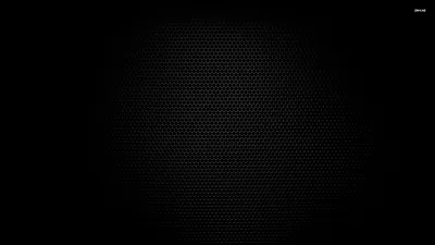A very fine honeycomb grid covers a dark panel, faintly lit through the centre and sinking into black at every edge.