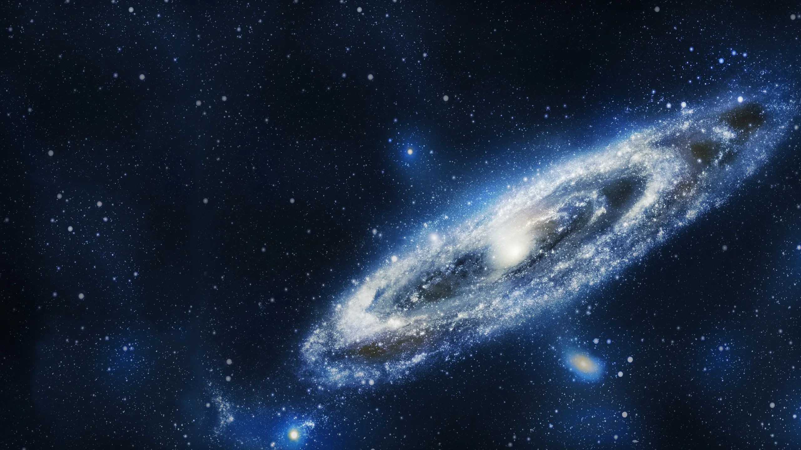 A large spiral galaxy leans to the right of the frame in blue and white, its dust lanes visible while the left side stays open black.
