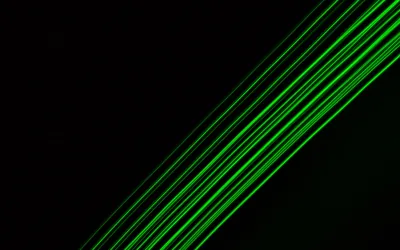 A bundle of thin green laser lines cuts diagonally from the lower left, leaving the upper corner in solid black.