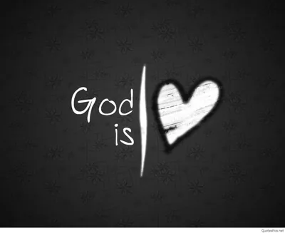 Chalk lettering reading God is beside a roughly drawn heart on a dark faintly patterned board, the strokes left smudged.